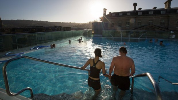 Bathers enjoy naturally warmed spa water as they relax in the rooftop pool of the Thermae Bath Spa, Britain's only natural thermal spa.