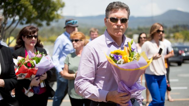 Dreamworld chief executive Craig Davidson leave flowers at the site last week.