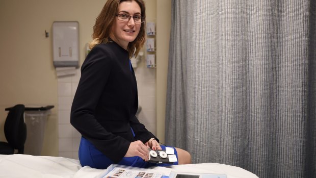 PhD Candidate Sarah McDonald, who is working with the RPA Women and Babies team, holds a proof-of-concept device for patches that will monitor pregnancy and labour progression.