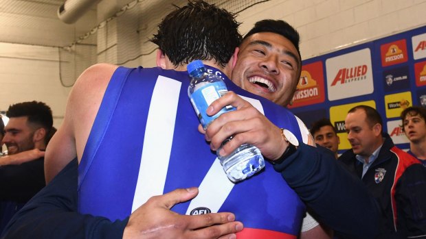 Tom Boyd and Lin Jong celebrate in the rooms after the Dogs' semi-final win.