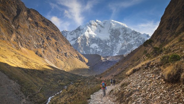 Tourists trekking up towards Salkantay Mountain in Peru.