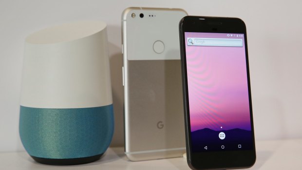 The new Google Pixel phone is displayed next to a Google Home smart speaker.