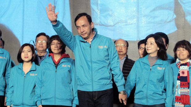Taiwan's ruling Nationalist candidate Eric Chu, front center, waves to supporters as he concedes defeat.
