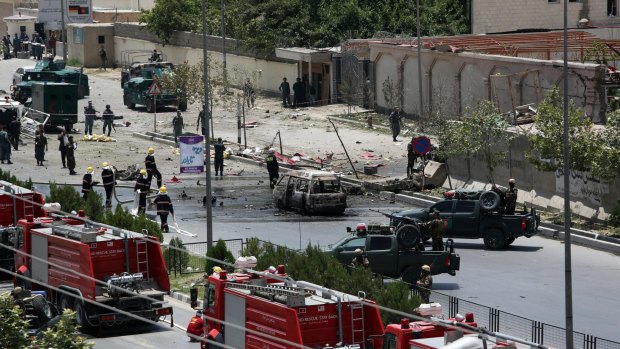 Afghan security forces and first responders  gather at the site of a complex attack by Taliban fighters in front of the Parliament in Kabul.