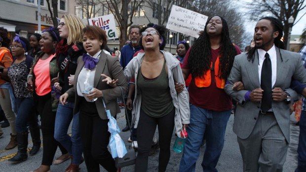 People protest over the shooting of Anthony Hill in Decatur, Georgia.