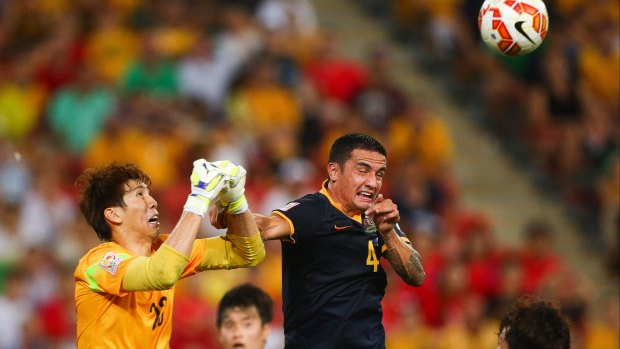 It’s just a setback: Tim Cahill battles Kim Jin-hyeon for the ball in the match against South Korea.