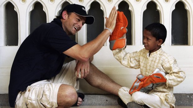 Adam Gilchrist with Mangesh, the child he sponsors through World Vision at the Taj Mahal hotel on October 17, 2006, in Mumbai.