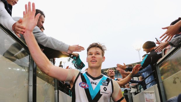 Port Adelaide's Logan Austin celebrates a recent win with fans.