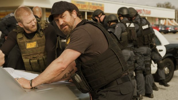Gerard Butler manages to swagger while remaining perfectly still in <i>Den of Thieves</i>.
