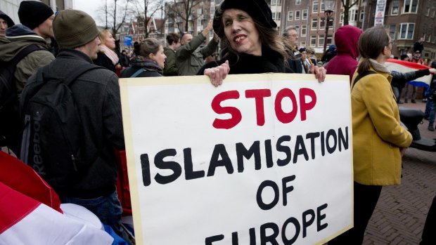 <b>A woman holds a placard during a Pegida demonstration against immigration and Islamisation in Amsterdam, Netherlands. in February.