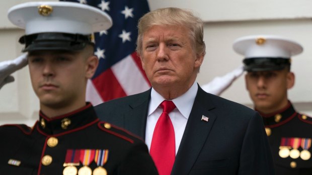 US President Donald Trump stands with a Marine honour guard for the arrival of Canadian Prime Minister Justin Trudeau at the White House on Wednesday.