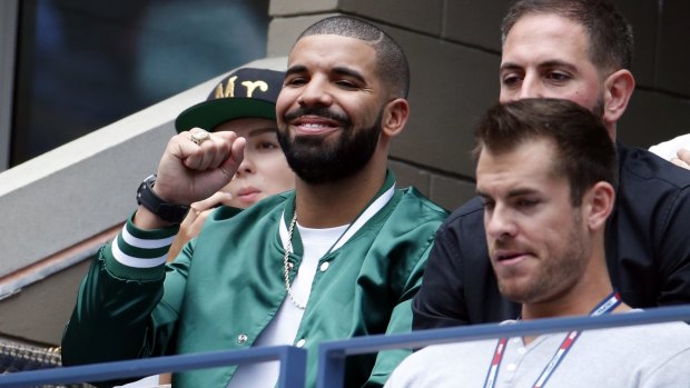 Bad omen: Rap star Drake cheers during his girlfriend Serena Williams' semi-final loss to Roberta Vinci at the US Open.