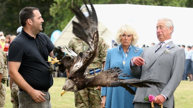 Prince Charles, Prince of Wales and Camilla, Duchess of Cornwall react as bald eagle Zephyr), mascot of the Army Air Corps flaps his wings last week.