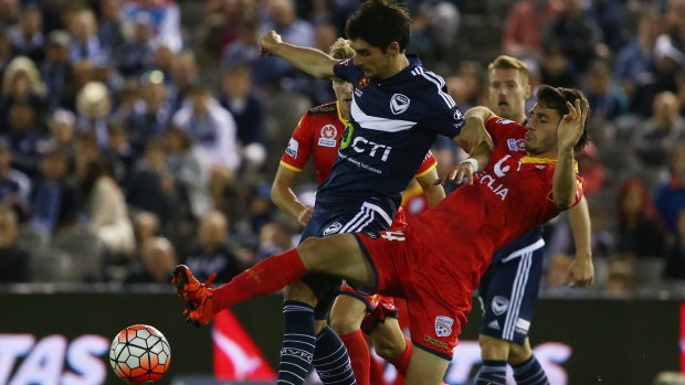 Gui Finkler of the Victory is challenged by George Mells of Adelaide United.