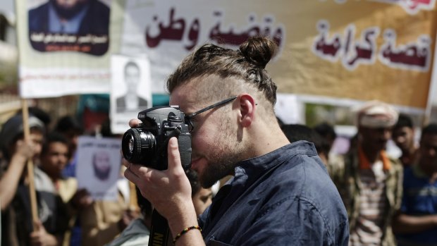 Luke Somers takes pictures of a demonstration against detention of Yemenis at Guantanamo Bay in the Yemeni capital Sanaa in April 2013.