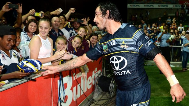 What a mighty fine man: Cowboys star Johnathan Thurston hands his headgear to a delighted fan in Townsville. 