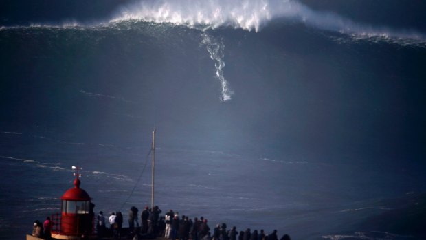 Crowds gather at Praia do Norte in Portugal to watch big-wave surfers tackle a monster swell.