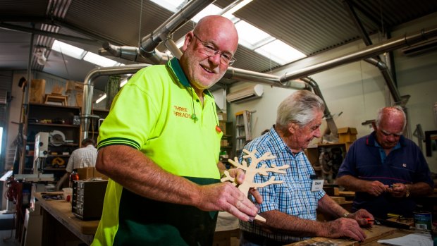 Belconnen Community Men's Shed manager, Gordon Cooper with members as residents in Page earn the closest to the national median income in the ACT.