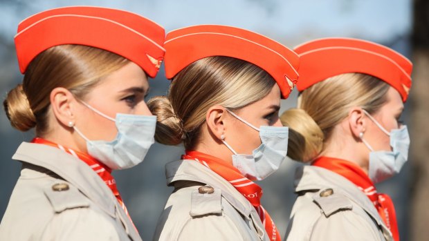 Aeroflot flight attendants wear masks at an event in October. The airline will move passengers who refuse to wear masks on board.