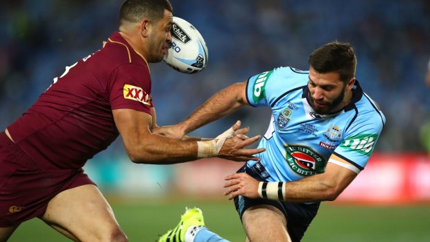 James Tedesco is tackled by Greg Inglis in the third State of Origin game in Sydney.