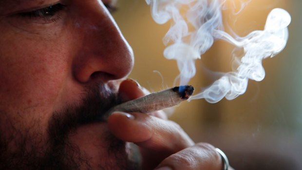 A former US Marine smokes medical marijuana in Belfast, Maine.