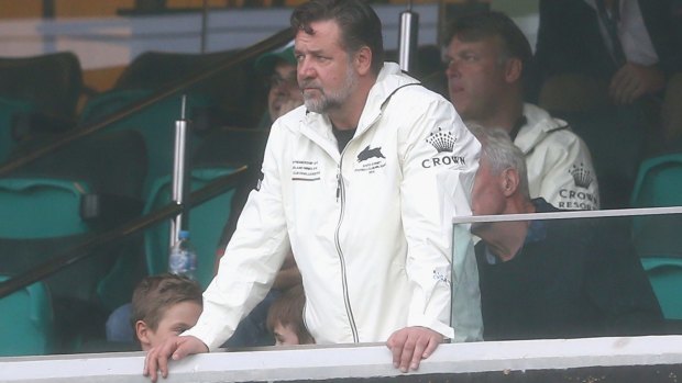 Anxious: Rabbitohs co-owner Russell Crowe watches Sam Burgess receive attention during the round three NRL match between the St George Illawarra Dragons and South Sydney at Sydney Cricket Ground.