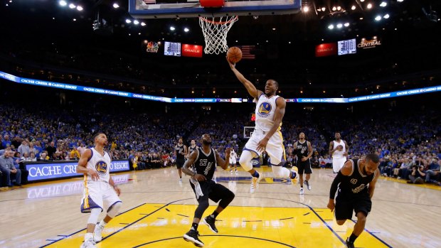 Lopsided: Andre Iguodala goes up for a shot against Jonathon Simmons and Patty Mills at ORACLE Arena.