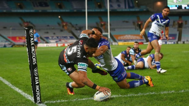 Touchdown: Valentine Holmes scores a try as he is tackled by William Hopoate on Monday night.