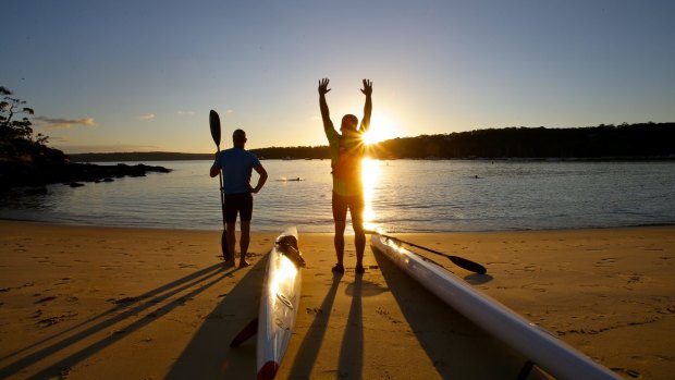 Early morning ski paddlers about to enter the water at Balmoral Beach.