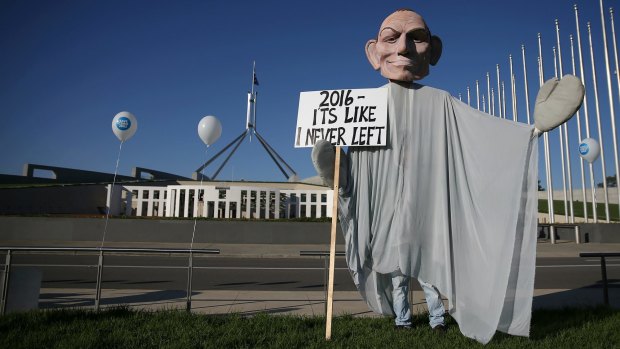 A man in a 'ghost of Tony Abbott' costume at the rally to save CSIRO jobs on the front lawn of Parliament House.