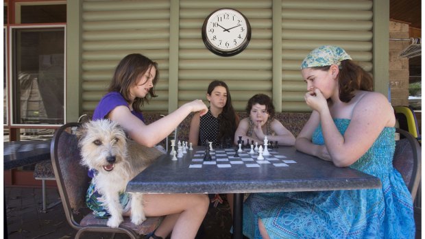 Josephine Blazier with her dog Ziggy, Morgan Gandolfo, Miriam Mitchell and Una Mitchell (with scarf on head), first in the National Chess Kids Championship held at Queens College in Melbourne.