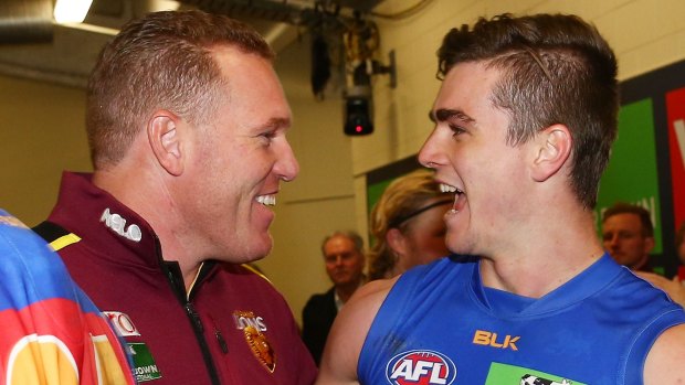 Justin time:  Lions coach Leppitsch celebrates with Ben Keays after beating the Bombers.