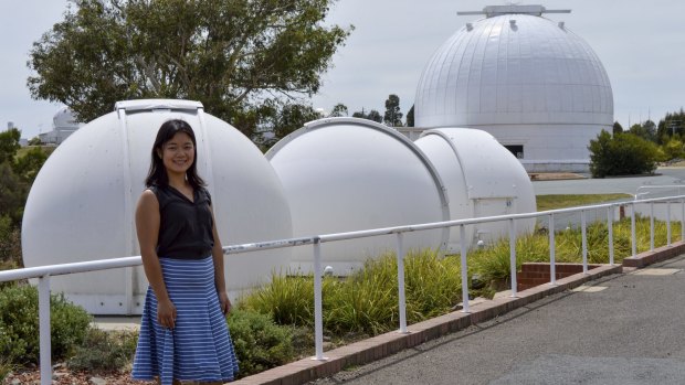 Bonnie Zhang shows off telescopes at the Mt Stromlo Observatory.