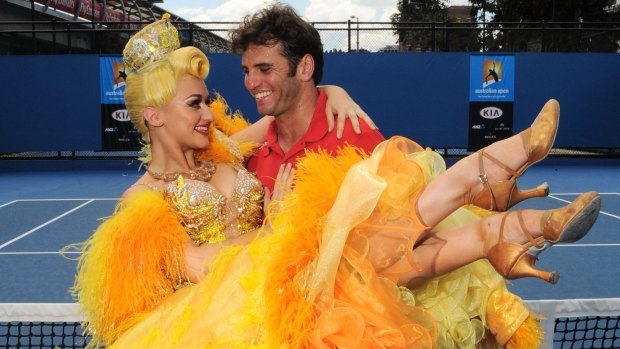 Sophia Katos from Strictly Ballroom the musical shows Malek Jaziri of Tunisia some dancing moves at the Open on Thursday.