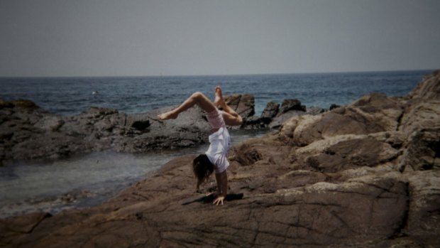 In a photo provided by her family, Lais Souza does a handstand during a trip to the beach. 