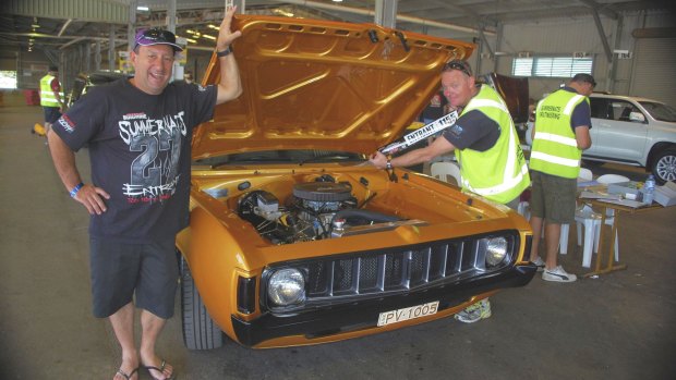 Paul Vezinias with his 1975 VJ Valiant Charger, and Colin Statton, a volunteer scrutineer and member of the ACT Street Machine car club. 
