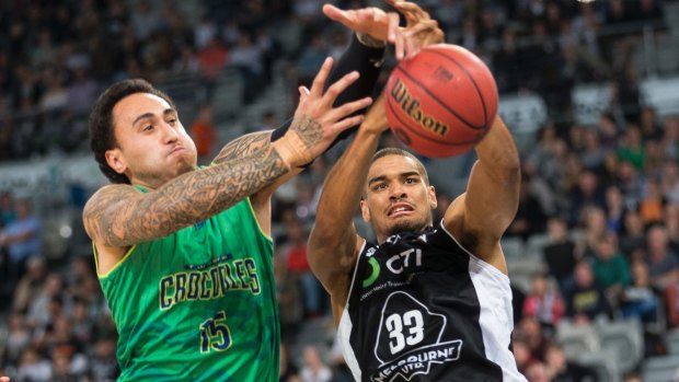 Hot contest: Townsville's Leon Henry and Melbourne United's Garrett Jackson compete for a rebound. 