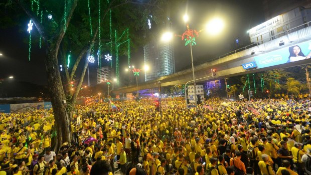 Protesters sit along a main road in Kuala Lumpur during a rally organised by pro-democracy group Bersih.