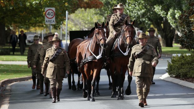 The AnzacCentennial Gun is marched down Scherger Drive during the official welcome to Canberra ceremony.