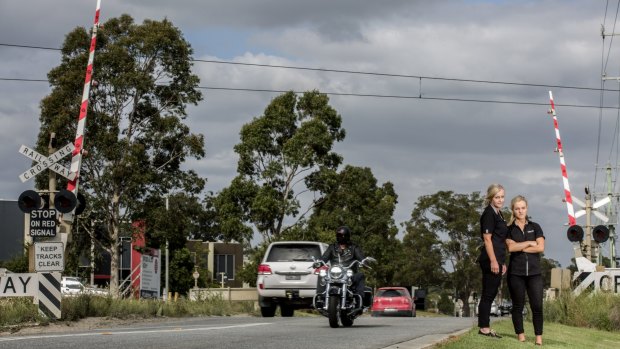 Business owners Darcie and Trish Bull at the Abbotts Road level crossing in Dandenong South.
