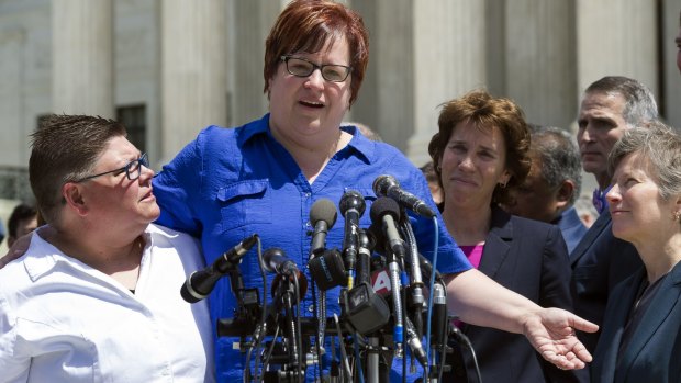 Michigan plaintiffs April DeBoer, centre, Jayne Rowse, left, and lawyers speak to reporters outside the Supreme Court in Washington on Tuesday.