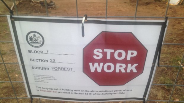 The stop work notice on the Forrest property, with the cleared section of the block in the background.