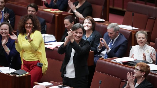 ALP Senator Penny Wong celebrates with colleagues after the Senate passes the bill.