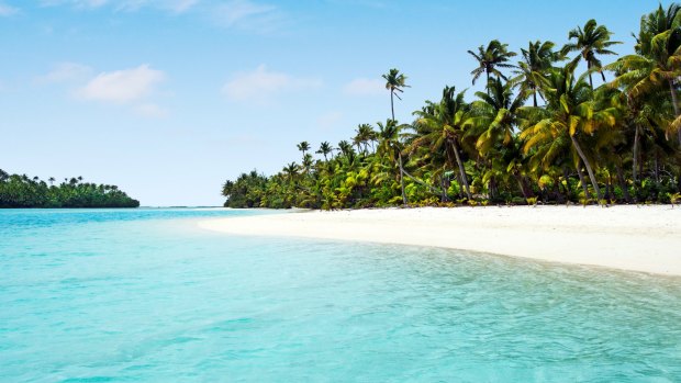One Foot Island, in the Cook Islands, where coconut trees form a ragged fringe above pristine beaches and swirling blue waters.
