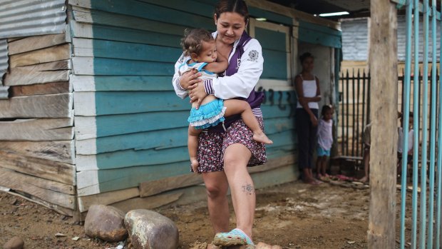 Nereida, with daughter Aranza, farmed to earn money in Venezuela until seeds were no longer available, forcing her to move the family across the border to Colombia.