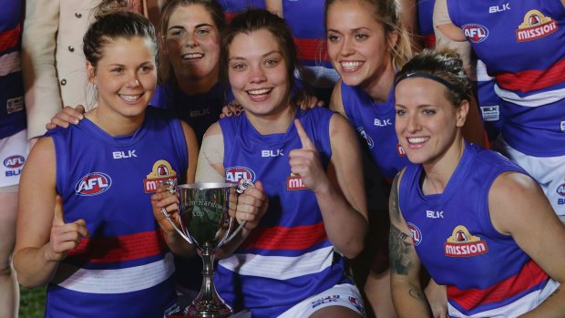 Meg Hutchins of the Bulldogs (centre) and teammates after winning the AFL Women's Exhibition Match last Saturday.