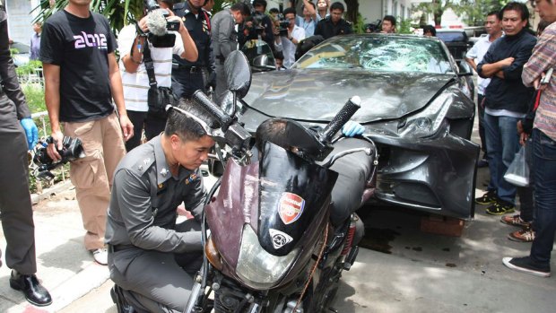 The Ferrari that was driven by Vorayuth Yoovidhya and a motorcycle, both involved in an accident, are displayed by police in Bangkok, Thailand.