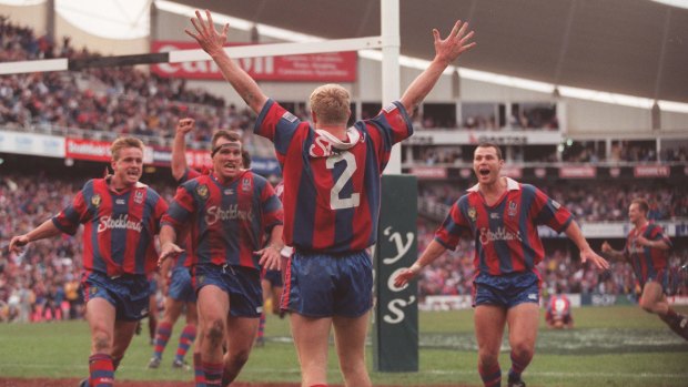Glory day: Newcastle players celebrate Darren Albert's amazing grand final-winning try in 1997.