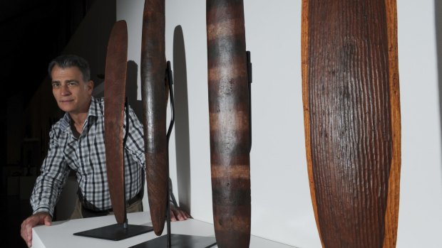 CMAG assistant director Mark Bayly with indigenous wood carvings in the Punuku Tjukurpa exhibition.