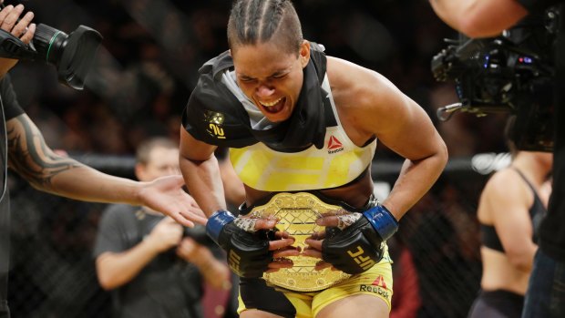 Amanda Nunes celebrates after winning the UFC's  women's bantamweight championship.